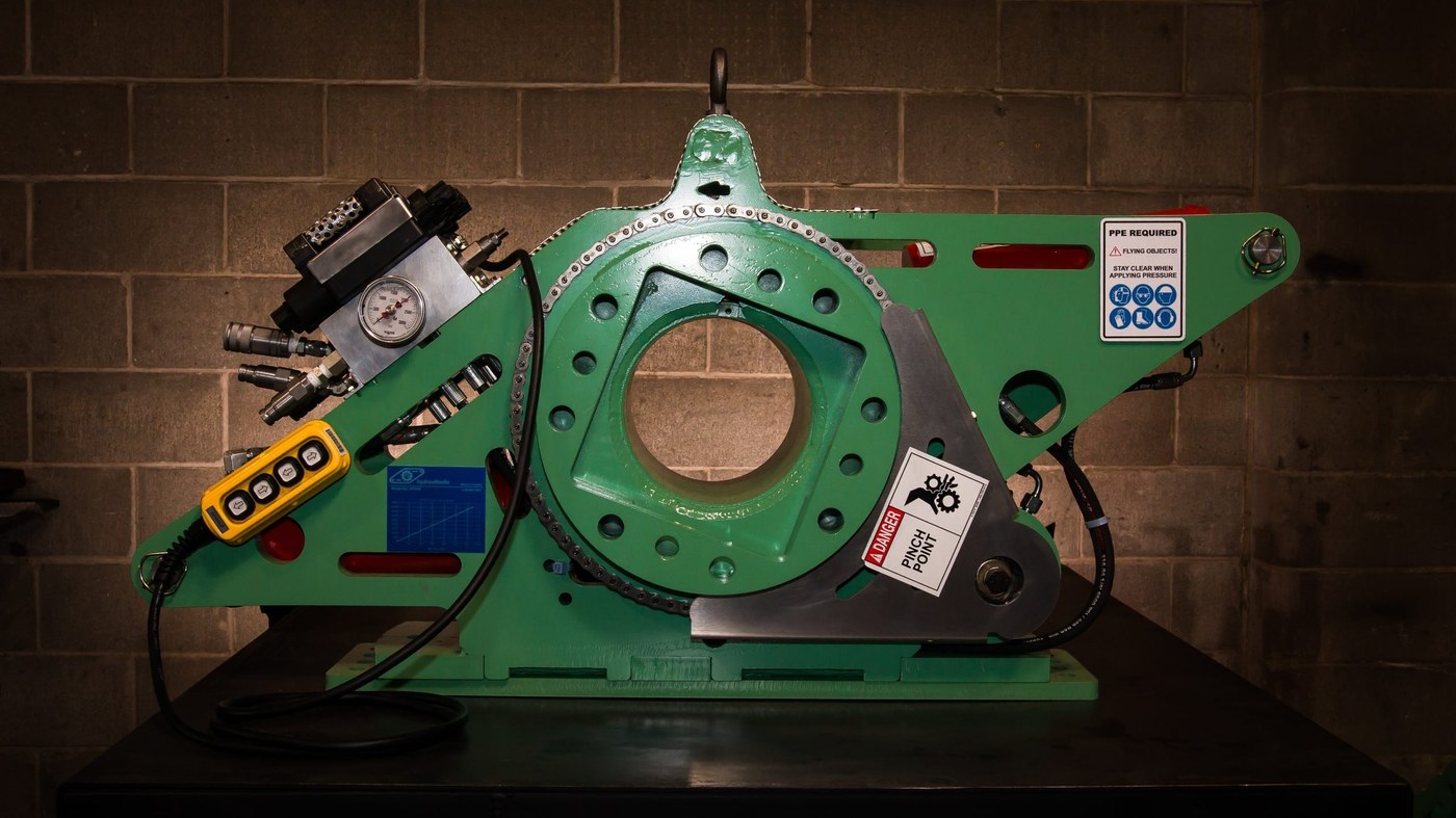 Large hydraulic torque tool mounted on heavy industrial cylinder — Santoo nut busting station